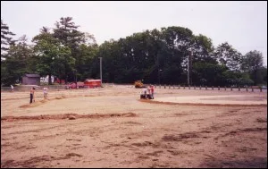Machine grading the sandy infield of a ball field