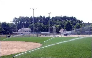 Sprinklers watering a baseball field